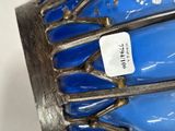 a close up of a blue vase with a tag on it