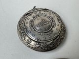 a silver locke with a picture of a ship on it