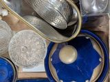 a wooden box filled with glass items on a table