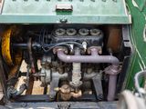 a close up view of an old engine in the back of a truck