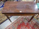a small wooden table with a label on top of it