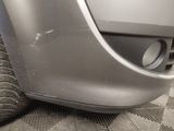 a close up of a car ' s front bumper and tire