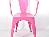une chaise rose posée sur une surface blanche