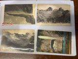four old postcards of mountains are displayed on a table