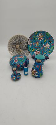 three pieces of blue and green pottery sitting on top of a table