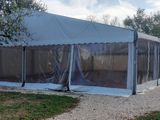 a large tent that is set up in the grass