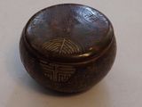 a small wooden box with writing on it on a table