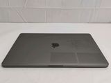 the back of an apple macbook pro laptop computer sitting on a white surface