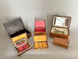 several small wooden boxes are lined up on a white surface