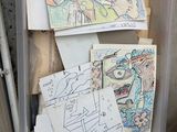a plastic container filled with lots of drawings and drawings