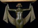 statue of a woman holding a large bowl on her head