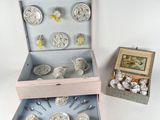 two boxes with silverware in them on a white surface
