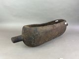 an old wooden boat with a handle on a white surface