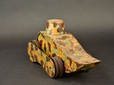 a wooden toy car with a camouflage pattern on it