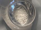 a close up of a silver vase with writing on it