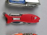 three different types of pocket knives are lined up on a table