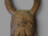 sculpture of a bull ' s head with horns on a gray background