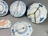 five plates with blue and white designs on them on a table