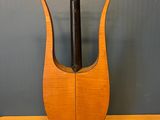 a wooden vase with a black handle on a wooden table