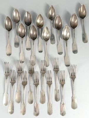 a lot of silver spoons and forks on a table