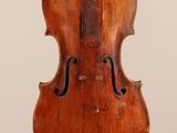 an old violin on a stand against a white background