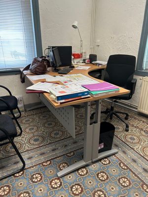 a desk with a chair and a computer on it