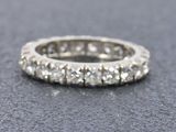 a close up of a diamond ring on a gray surface