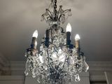 a crystal chandelier hanging from the ceiling in a room
