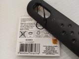 a black object on a white surface with a barcode on it