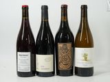 four bottles of wine are lined up on a white surface