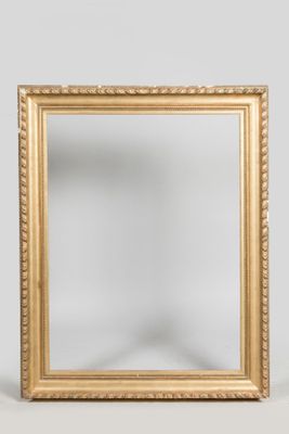 une image représentant un miroir à cadre doré posé contre un mur blanc