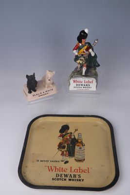 a small tray with a bottle of white label and a small figurine of a man
