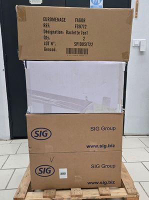 boxes stacked on top of each other on a pallet in front of a door