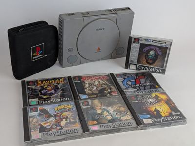 a lot of video games on the table with a case