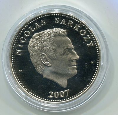 a close up of a coin with a man ' s face on it