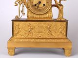 a gold clock that is sitting on top of a table