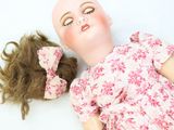 a doll that is laying down on the ground