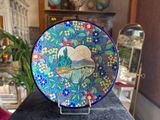 a colorful plate with a picture of a landscape on it