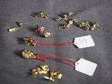 a lot of small gold studs and a price tag on a table