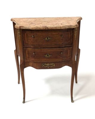 a small wooden chest of drawers with a marble top