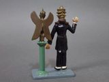 a figurine of a man with a bird on top of a pedestal