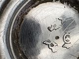 a close up of a silver plate with numbers on it