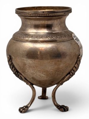 a silver vase on a stand on a white background