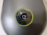 a close up of a computer mouse with a green button
