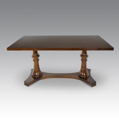 a wooden table with a square top on a pedestal