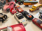 many toy cars and trucks on the table together