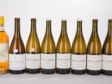 six bottles of wine are lined up in a row on a table