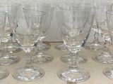 six empty wine glasses sitting on top of a wooden tray