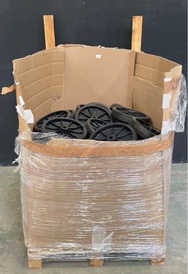 a cardboard box full of tires in the middle of the floor