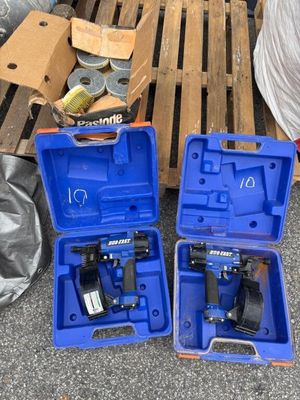 two blue tools are sitting on a pallet next to a pallet